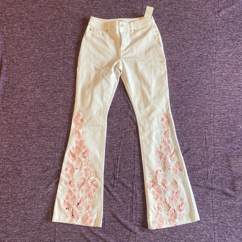 White flare jeans with pink detailing